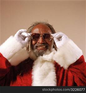 Cool African American Santa Claus Straightening His Glasses And Smiling