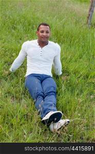 Cool African handsome guy sitting on the grass