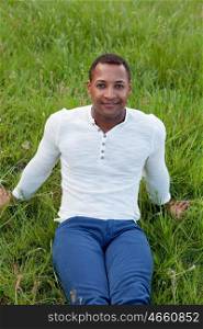 Cool African handsome guy sitting on the grass