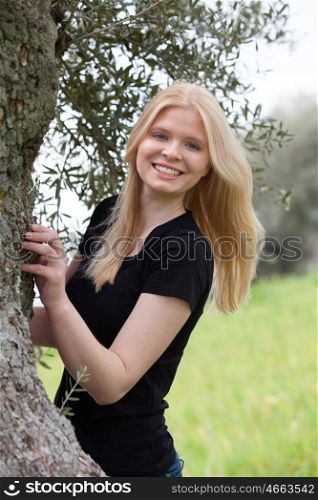 Cool blonde girl posing surrounded by nature
