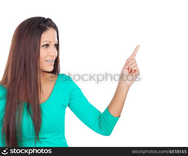 Cool brunette girl inidicating something with her finger isolated on a white background