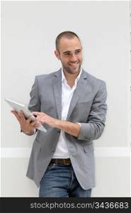 Cool businessman using electronic tablet on white background