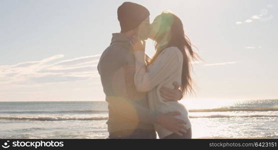 Cool Couple Laughing and hugging In Front Of Beach at beautiful autumn day