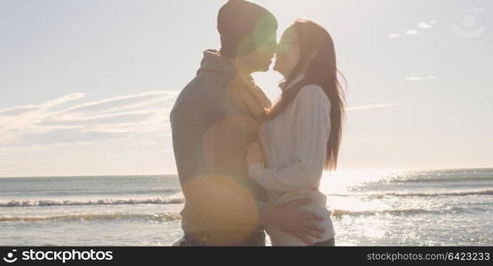 Cool Couple Laughing and hugging In Front Of Beach at beautiful autumn day