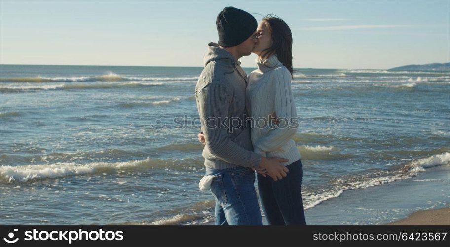 Cool Couple Laughing and hugging In Front Of Beach at beautiful autumn day