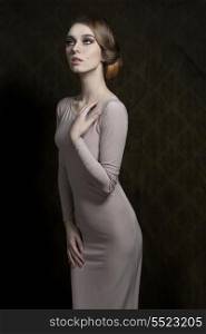 cool fashion portrait of slim woman with elegant style, gray dress and classic hair-style.