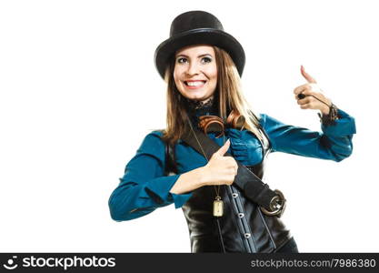 Cool girl in steampunk style.. Smiling young steampunk islolated girl on white wearing fancy hat. Fantasy old fashion wearing stylish topper and goggle with thumbs up gesture.