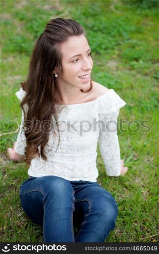 Cool girl sitting on the grass in the park