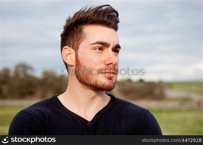 Cool handsome guy with beard at outside