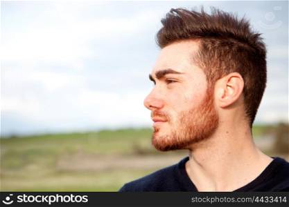 Cool handsome guy with beard looking at side