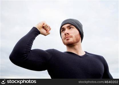 Cool handsome guy with strong arms at outside