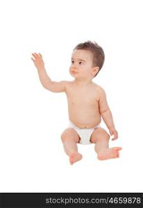 Cool little baby sitting on the floor with diaper isolated on a white background