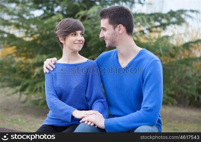 Cool lovers in the park dressed in blue