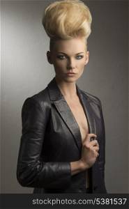 cool portrait of charming blonde girl with fashion rock style, creative hairdo and leather jacket