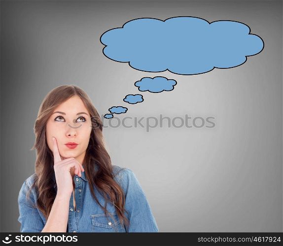 Cool preteen girl thinking something on a grey background