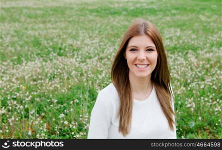 Cool pretty girl in the meadow surrounded flowers