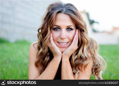 Cool pretty girl lying on the grass with a beautiful smile