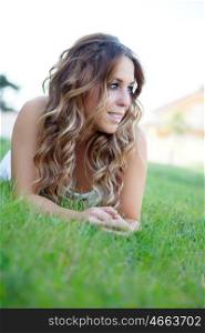 Cool pretty girl lying on the grass with a beautiful smile