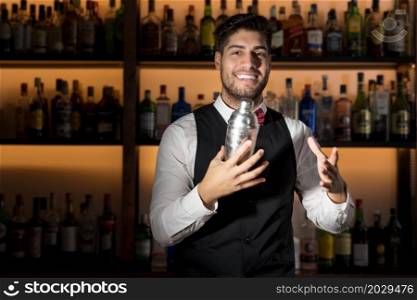 Cool professional bartender making a cocktail, shaking a cocktail shaker. Authentic barman making alcohol beverages in modern bar. High quality photo.. Cool professional bartender making a cocktail, shaking a cocktail shaker. Authentic barman making alcohol beverages in modern bar.