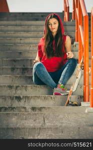 Cool skater young long haired girl with skateboard sitting on the urban stairs. Active lifestyle funky in summer. Outdoor trendy sport teenage.. Skate girl on stairs with skateboard.