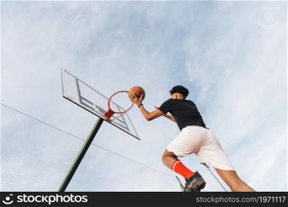 cool sporty man throwing basketball into hoop. High resolution photo. cool sporty man throwing basketball into hoop. High quality photo