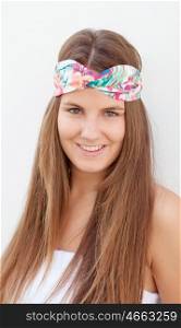 Cool trendy girl with a flowered hair scarf smiling