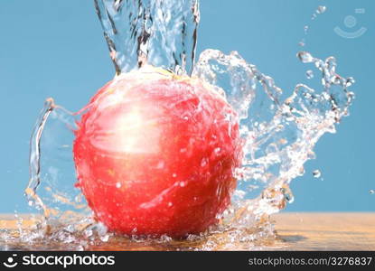 cool water drop on rose color apple, frozen splash