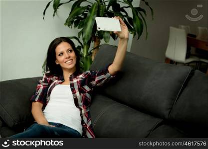 Cool woman at home taking a picture with mobile