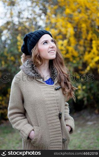 Cool woman with wool cap and a beautiful background with yellow flowers