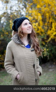 Cool woman with wool cap and a beautiful background with yellow flowers