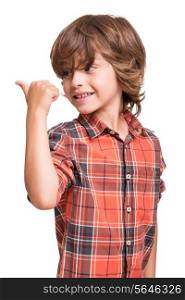 Cool young boy pointing to empty space over white