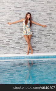 Cool young girl on the edge of the pool