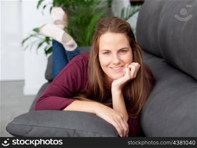 Cool young woman lying on the sofa at home
