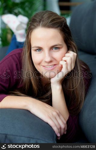 Cool young woman sitting on the sofa at home