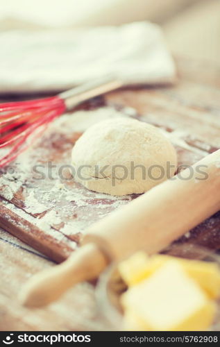 cooling and home concept - close up of bread dough on cutting board