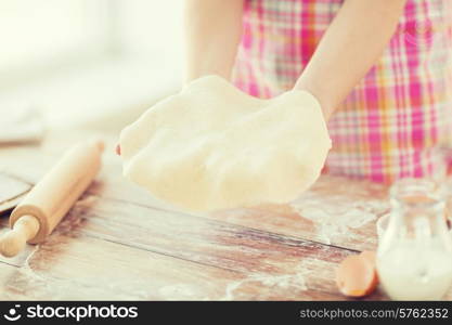 cooling and home concept - close up of female hands holding bread dough