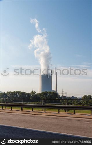 Cooling tower of a factory with white smoke