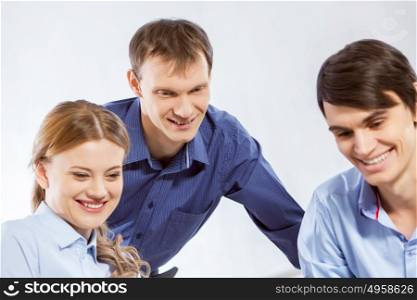 Cooperate for productive work. Three co-workers discussing business ideas in office