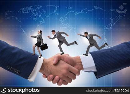 Cooperation concept with people running on handshake. The cooperation concept with people running on handshake