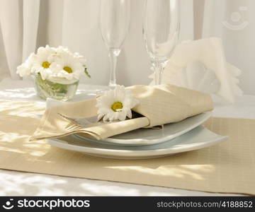 Coordinated decorative napkin on a plate with cutlery