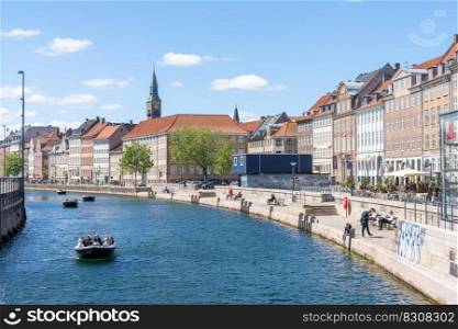 Copenhagen, Denmark - 13 June, 2021  people enjoy a recreational boat cruise on the canals of Copenhagen on a beautiful summer day