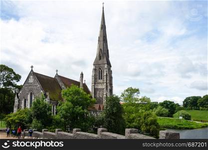 Copenhagen, Denmark - July 24, 2017: Tourists visiting famous St Albans Anglican Church in Copenhagen. Church designed by Arthur Blomfield in Gothic Revival style and built in 1887.