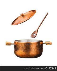Copper cooking pot with flying open lid and wooden spoon, isolated on white background, front view