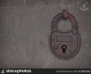 copper padlock on a heavy metal rusty old steel plate, with space for text or symbol