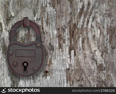 copper padlock on a weathered old wooden floor, with space for text or symbol