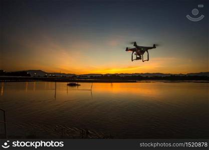 copter drone flying at sunset