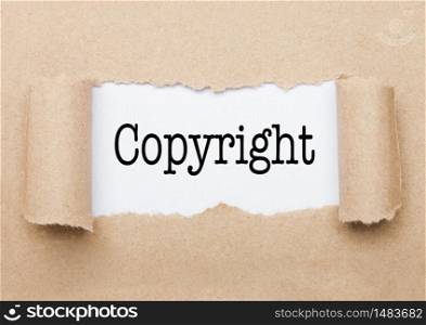 Copyright concept text appearing behind torn brown paper envelope