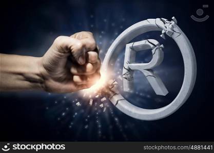 Copywriting symbol. Close up of human hand touching broken copywriting sign