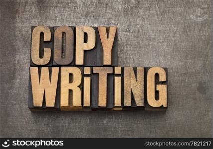 copywriting word - vintage letterpress wood type on a grunge metal background
