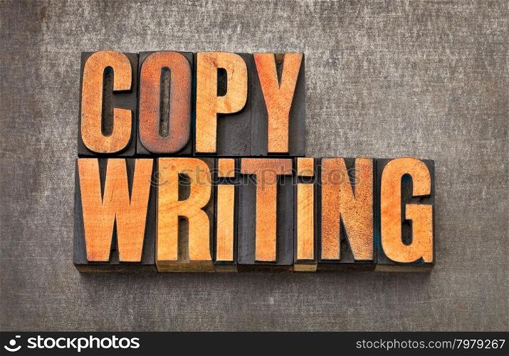 copywriting word - vintage letterpress wood type stained by red ink on a grunge metal background